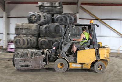 forklift truck moving a tyre bale around our plant using a clamp attachment